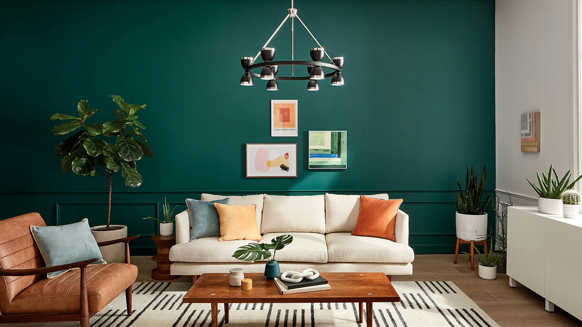 Contemporary living room with dark green wall and southwest color palette furnishing featuring a Baland chandelier