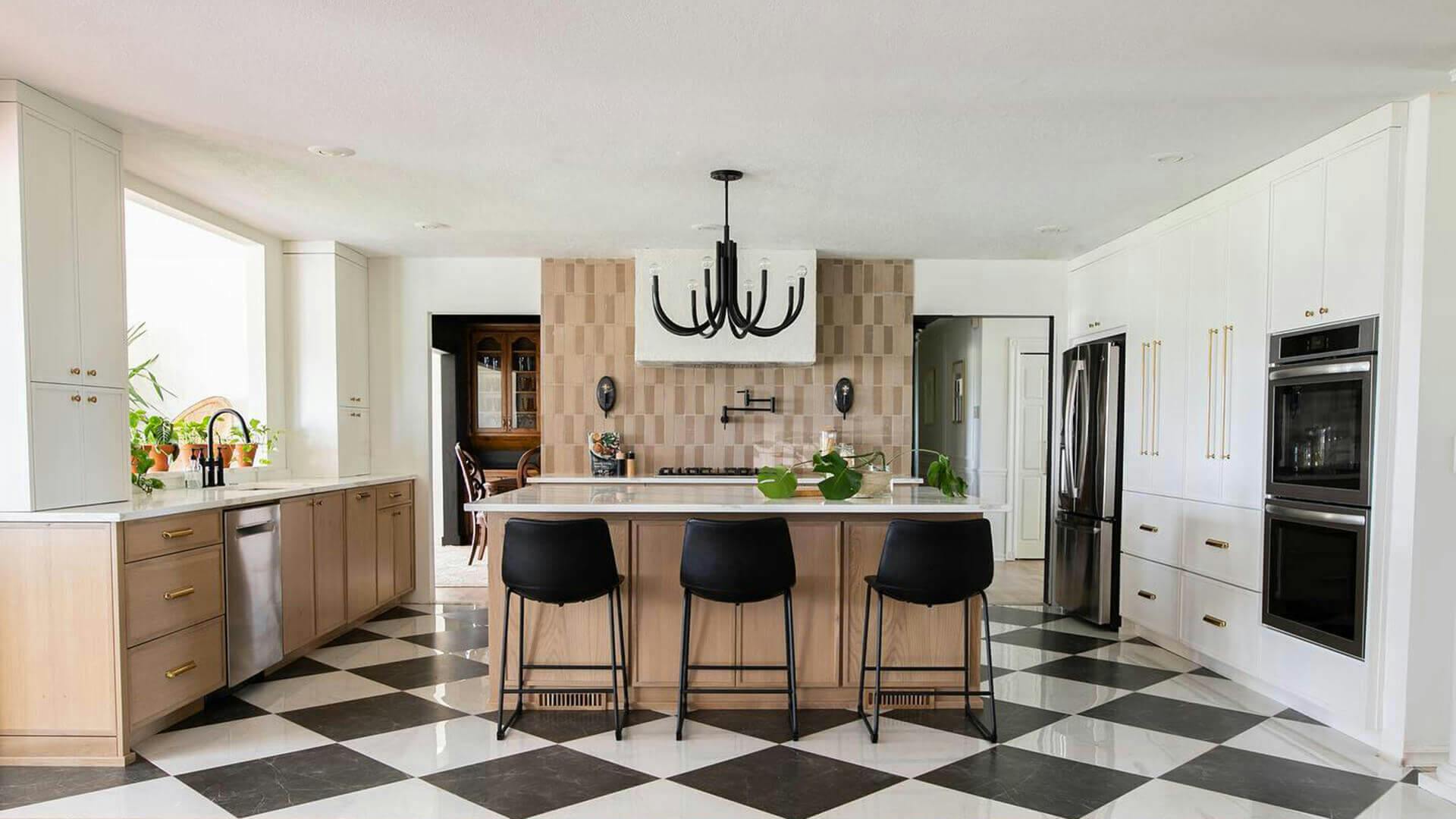 Art deco kitchen with mixed woods and patterns featuring a black odensa chandelier