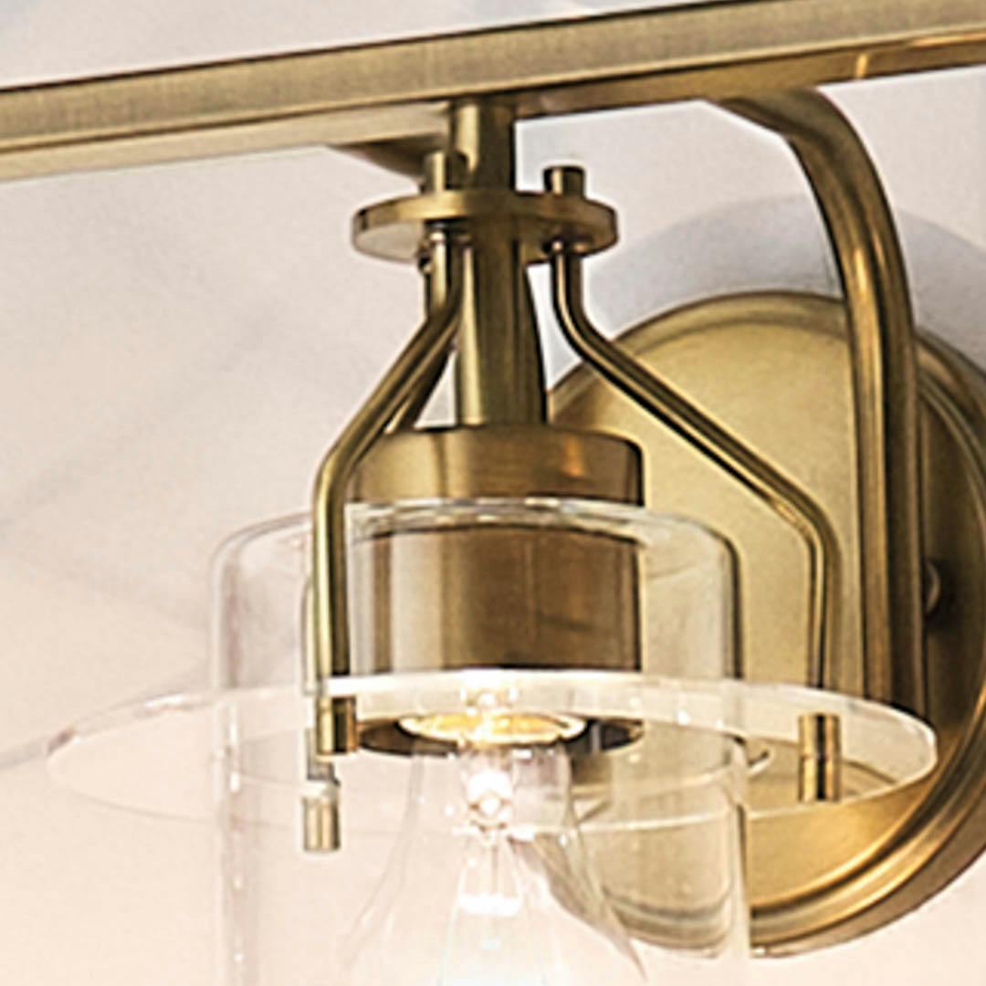 Day time bathroom with Everett 24 Inch 3 Light Vanity Light with Clear Glass in Natural Brass