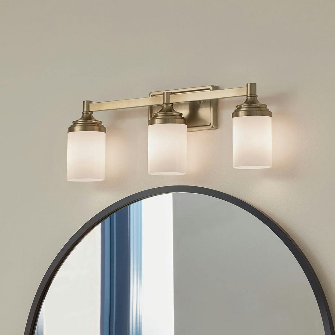 Bathroom in day light with the Noha 24 In. 3-Light Champagne Bronze Vanity Light with Opal Glass Shades