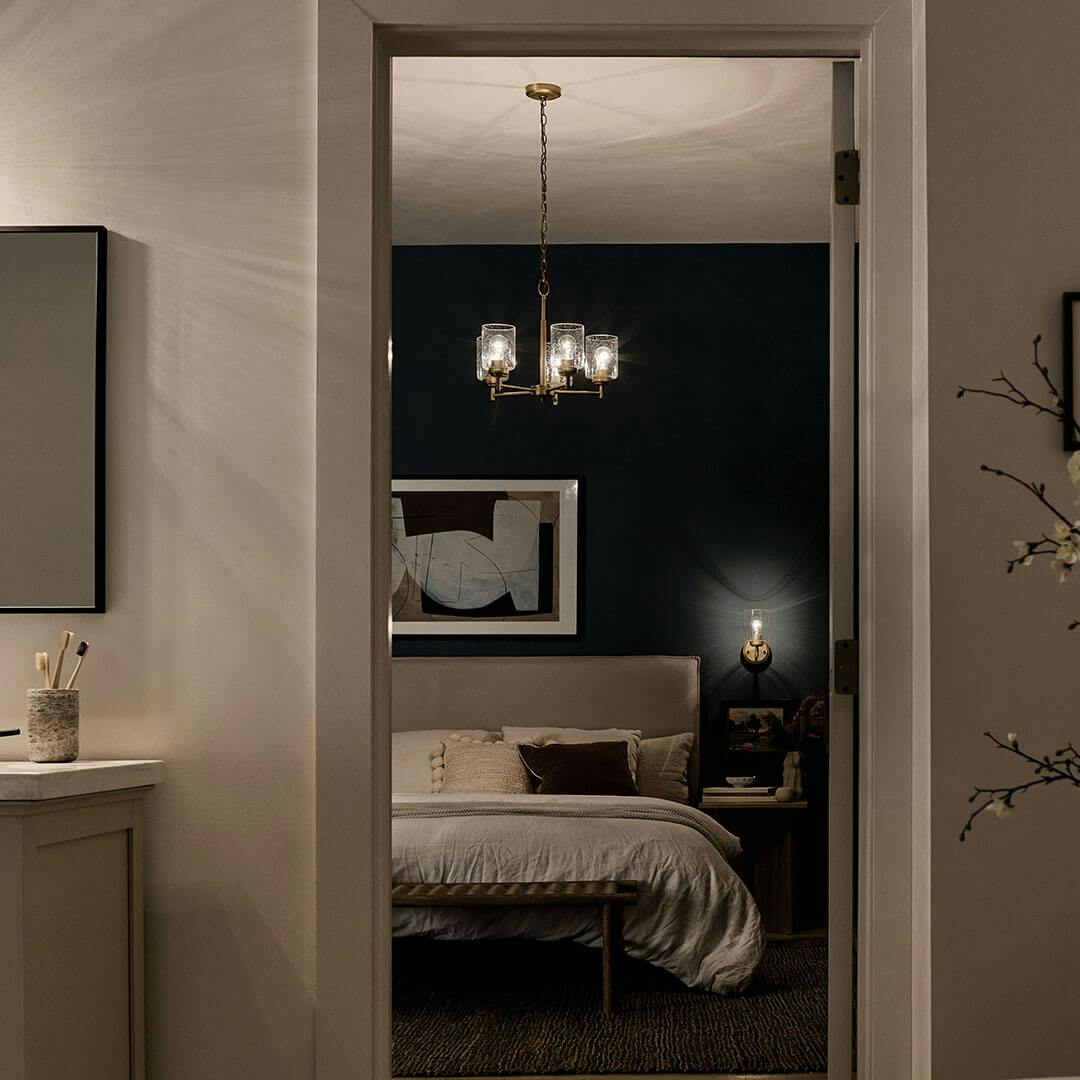 Bedroom at night with the Winslow 16.25" 5-Light Chandelier in Natural Brass