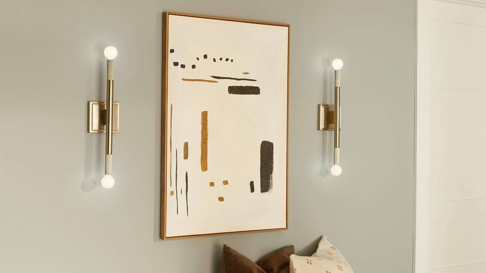 Artwork flanked with Odensa sconces 