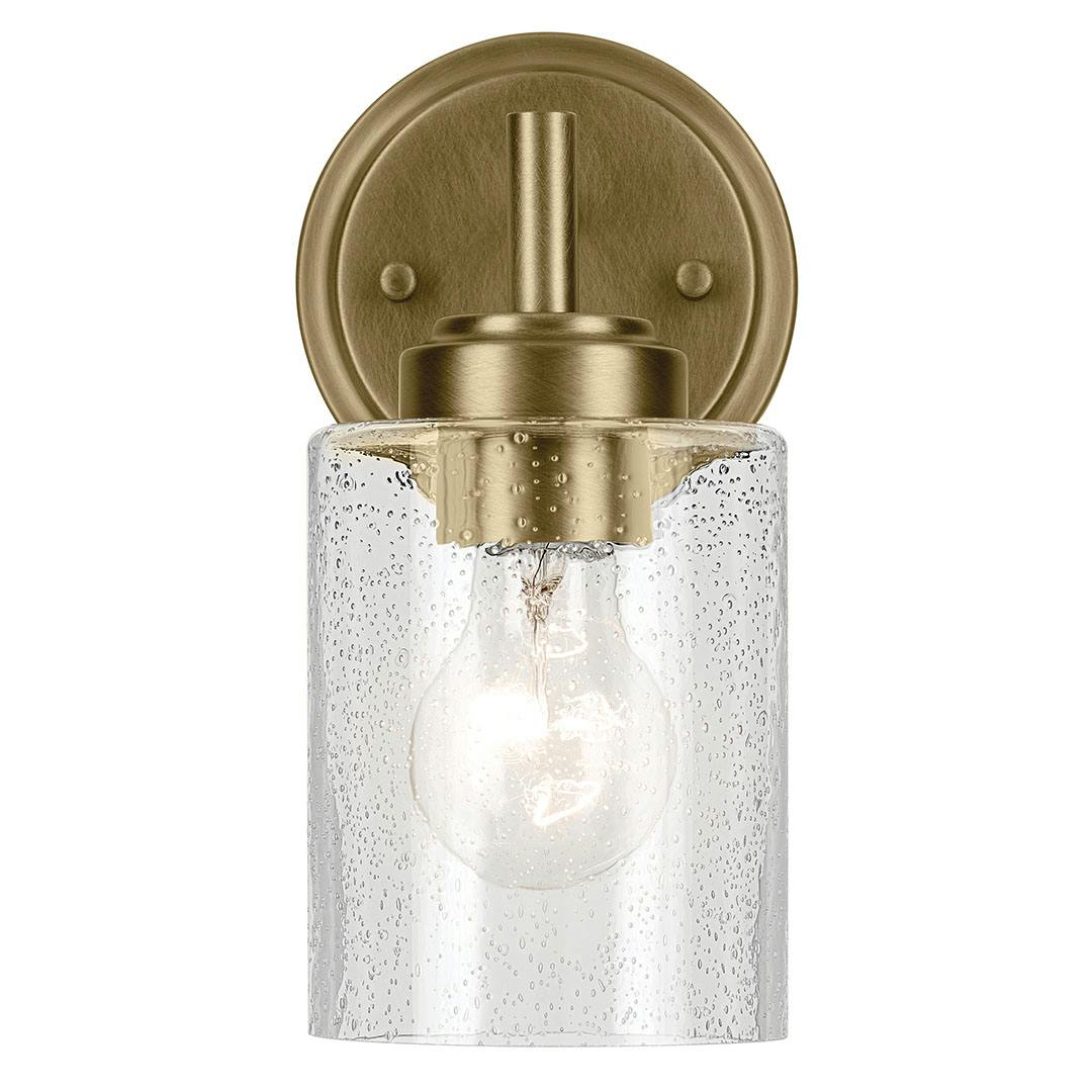 The Winslow 9.25" 1-Light Wall Sconce with Clear Seeded Glass in Natural Brass mounted down on a white background