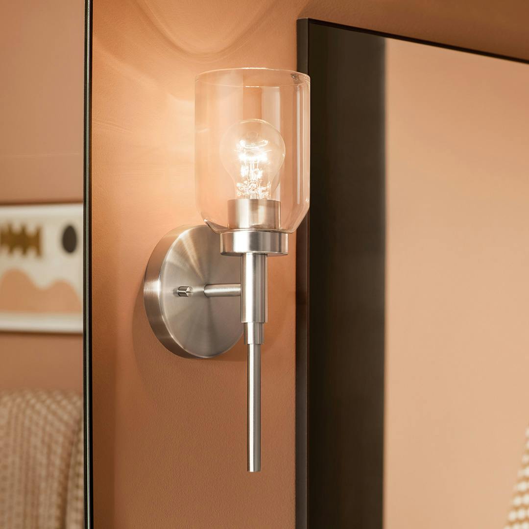 Day time bathroom featuring the Madden 14.75 Inch 1 Light Wall Sconce with Clear Glass in Brushed Nickel