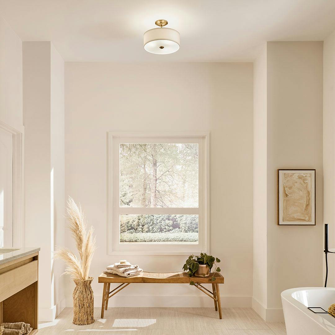 Bathroom in day light with the Shailene 10" 3-Light Small Round Semi Flush in Natural Brass
