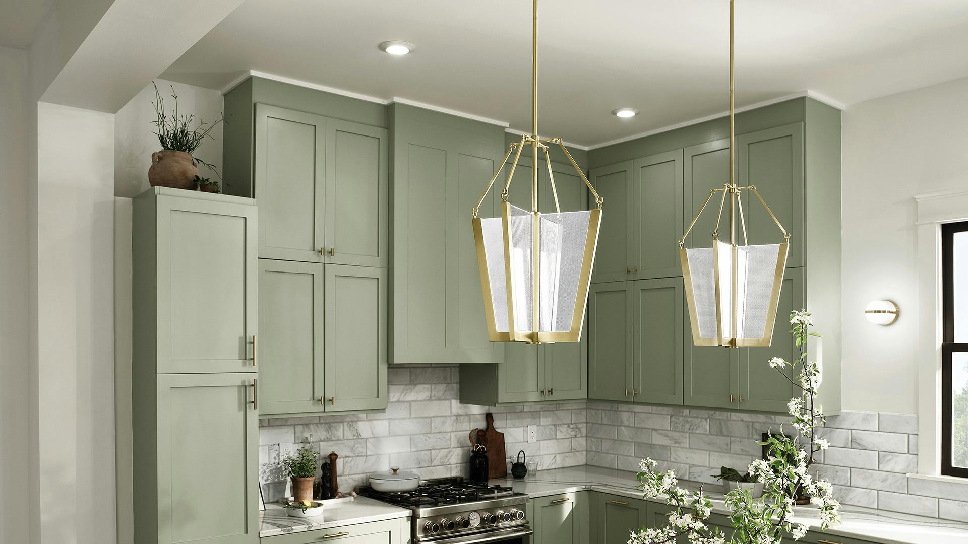 Bright, fresh kitchen with sage green cabinets and Carter's pendants over the counter