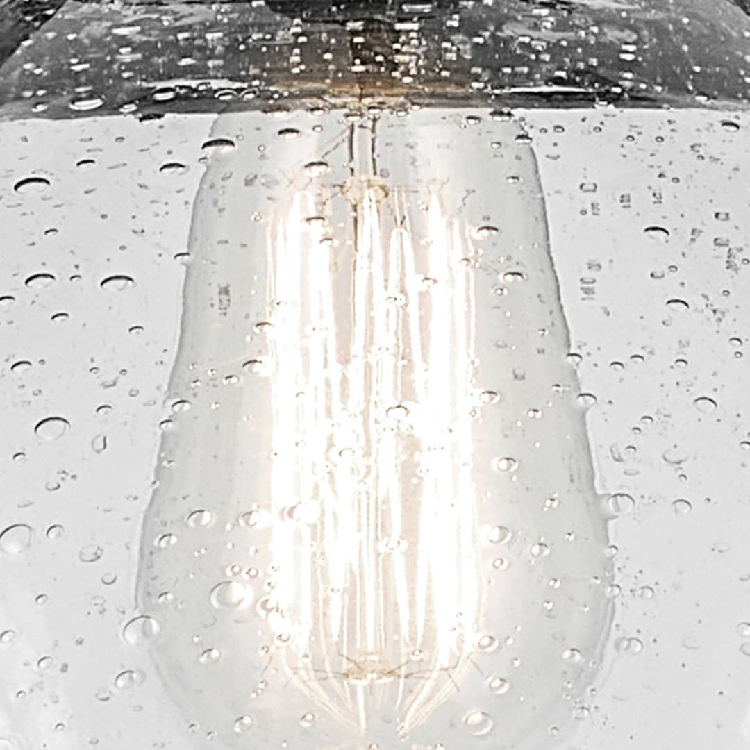 Close up of the Avery 11" 1-Light Dome Pendant with Clear Seeded Glass in Olde Bronze