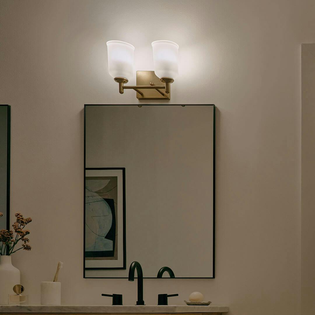 Bathroom at night with the Shailene 12.5" 2-Light Vanity Light in Natural Brass