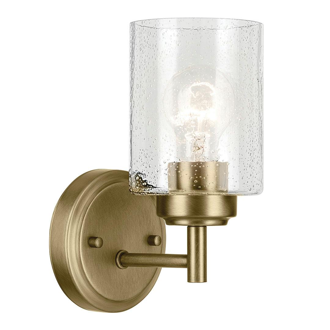 The Winslow 9.25" 1-Light Wall Sconce with Clear Seeded Glass in Natural Brass on a white background