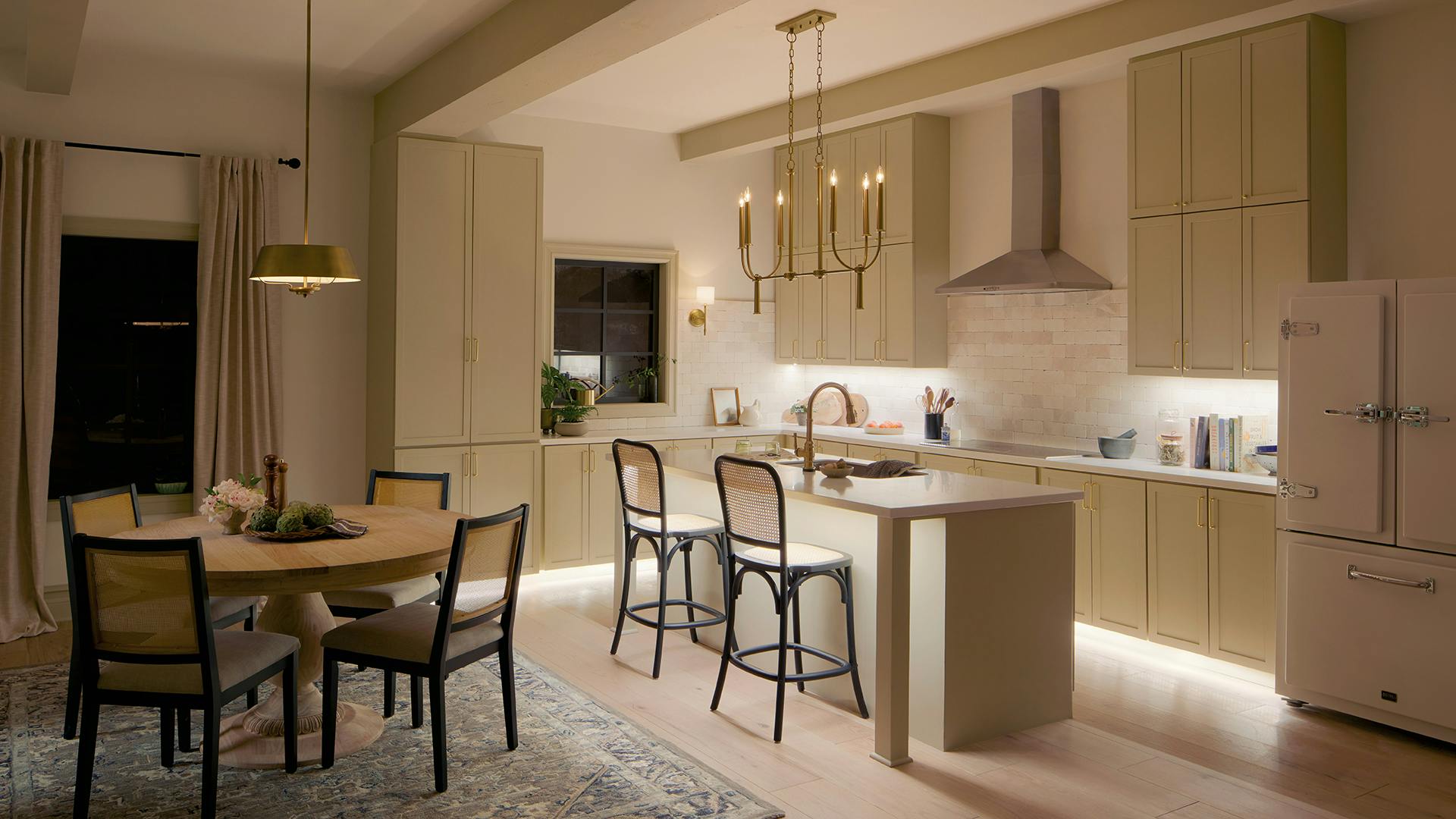 Kitchen with light layers like task, chandelier and sconces.