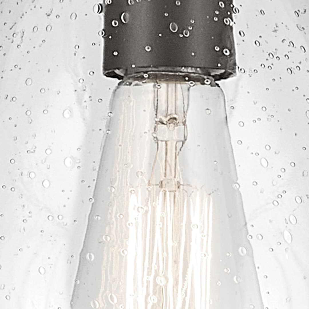 Close up view of the Everly 13.75" 1-Light Bell Pendant with Clear Seeded Glass in Olde Bronze on a white background