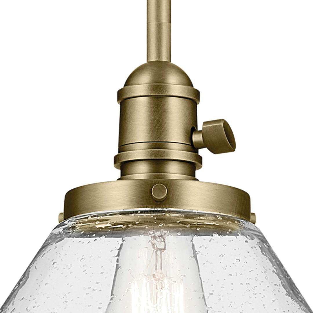 Close up view of the Avery 11.75" 1-Light Cone Pendant with Clear Seeded Glass in Natural Brass on a white background