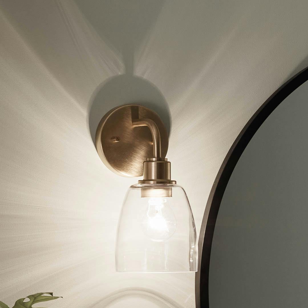 Night time bathroom with Meller 11.2.5 Inch 1 Light Wall Sconce with Clear Glass in Champagne Bronze