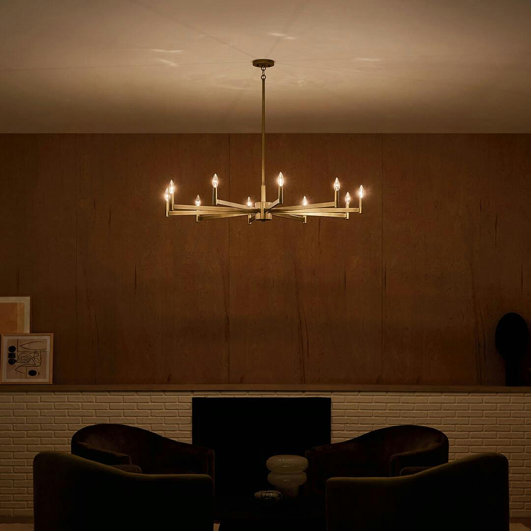 Den at night with the Erzo 48" 10 Light Chandelier in Natural Brass