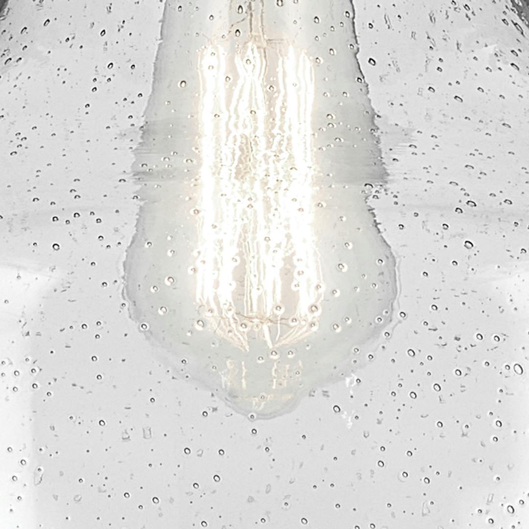 Close up view of the Avery 11.25" 1-Light Bell Pendant with Clear Seeded Glass in Olde Bronze on a white background