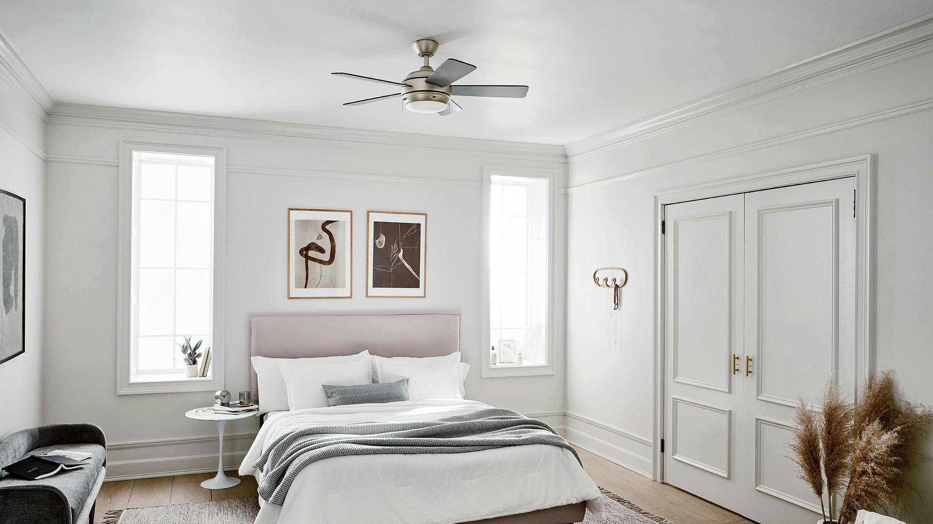 Bright, white bedroom featuring Starkk fan over the bed.