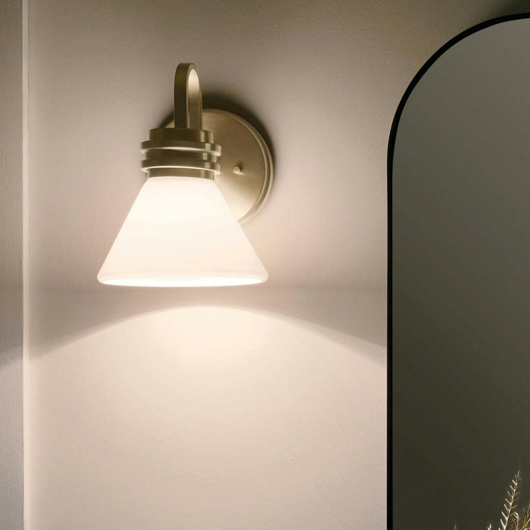 Night time bathroom with the Farum 9.5 Inch 1 Light Wall Sconce with Opal Glass in Champagne Bronze
