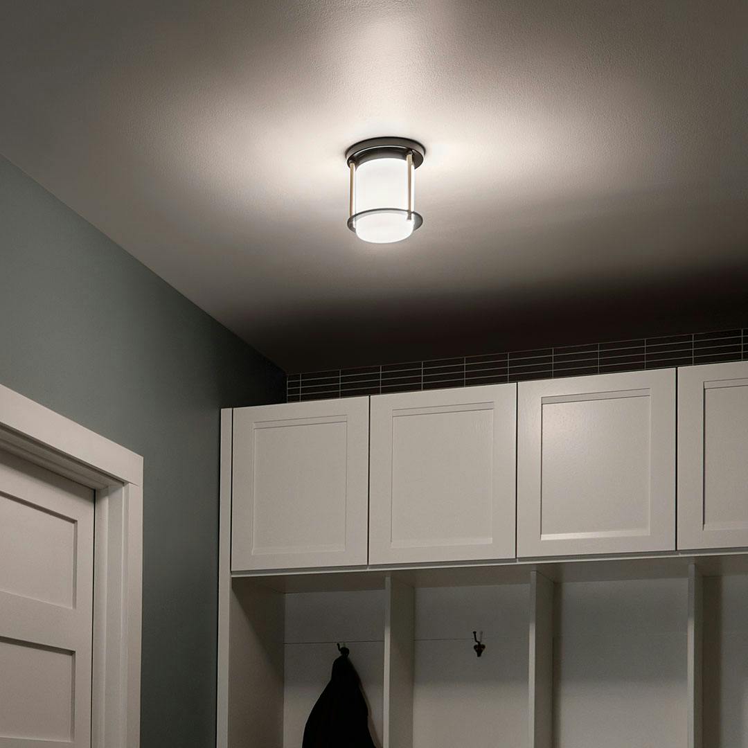 Night time mudroom with Brit 7.25 Inch 1 Light Flush Mount with Satin Etched Cased Opal Glass in Black and Champagne Bronze