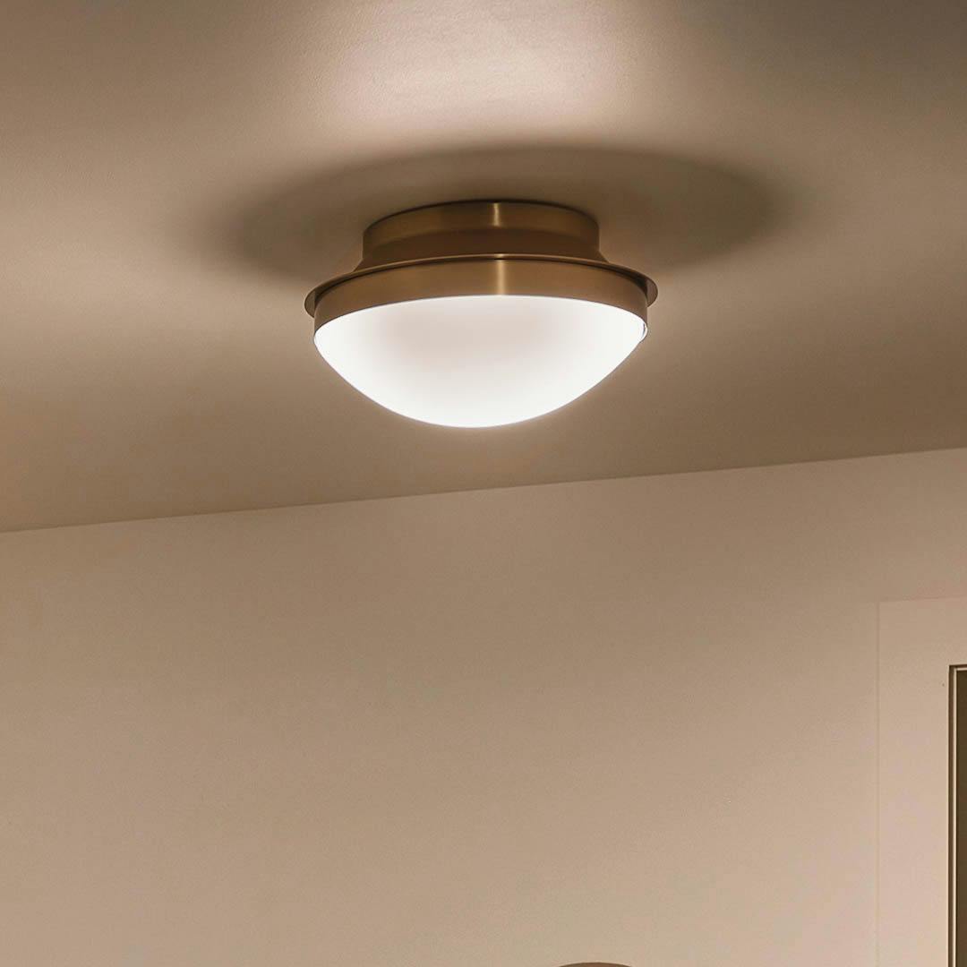 Night time entryway with Bretta 13.5" 2 Light Flush Mount Brushed Natural Brass