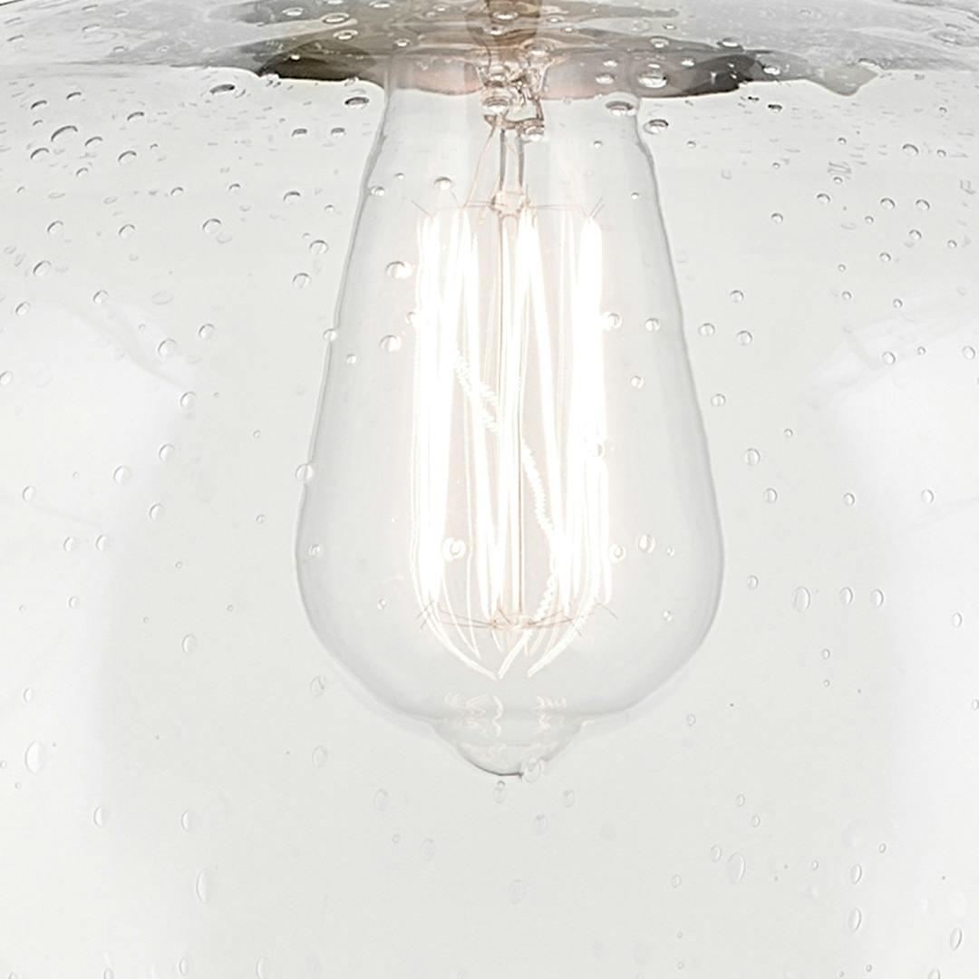 Close up view of the Avery 14" 1-Light Globe Pendant with Clear Seeded Glass in Natural Brass on a white background