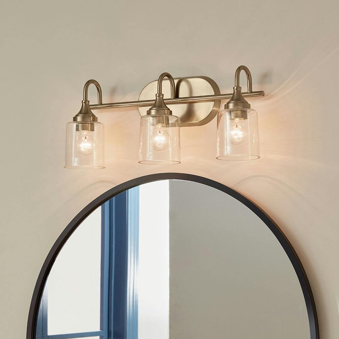 Bathroom in day light with the Erta 24 In. 3-Light Champagne Bronze Vanity Light with Clear Glass Shades