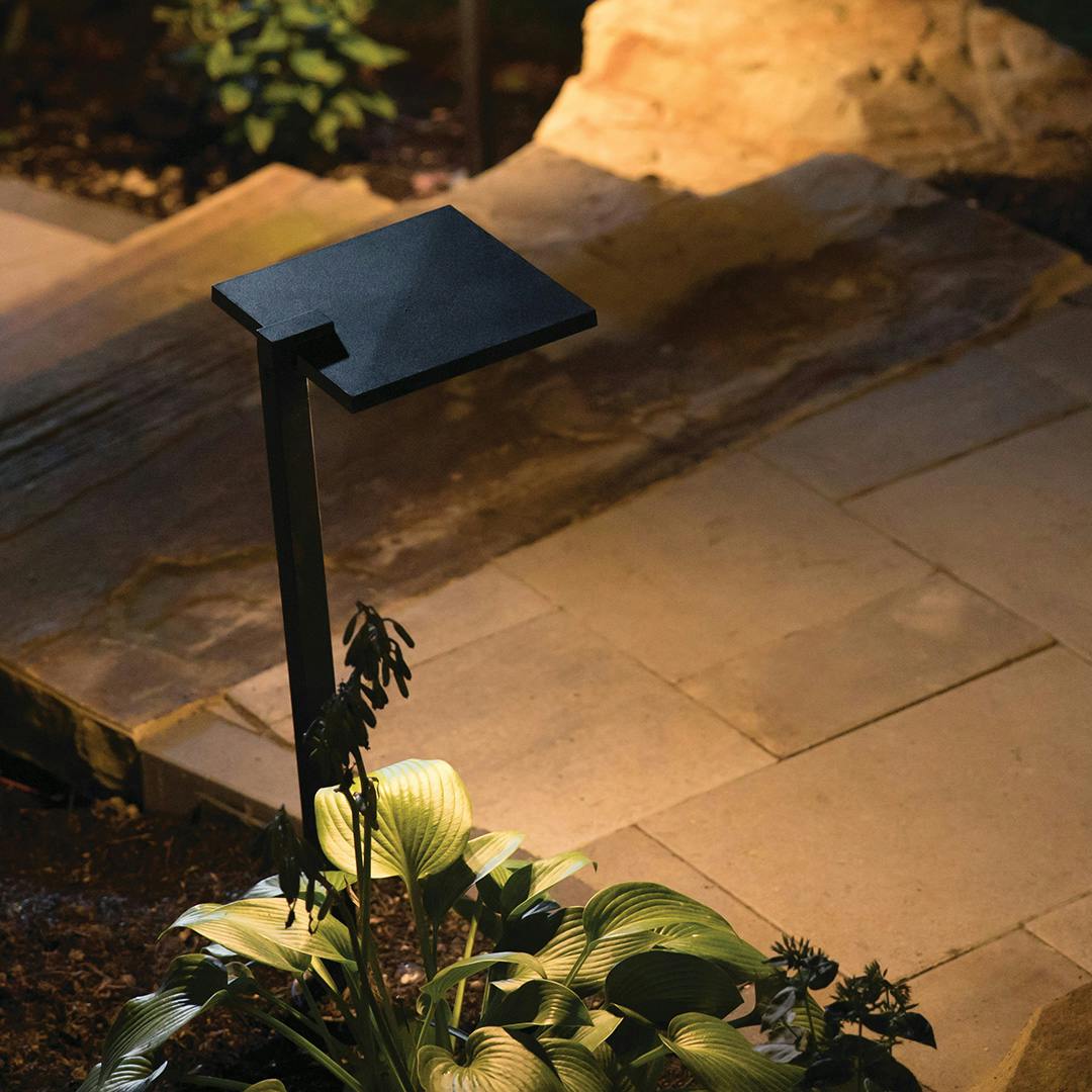The 12 Volt 2700K LED 8" Shallow Shade Path Light in Textured Black outside at night