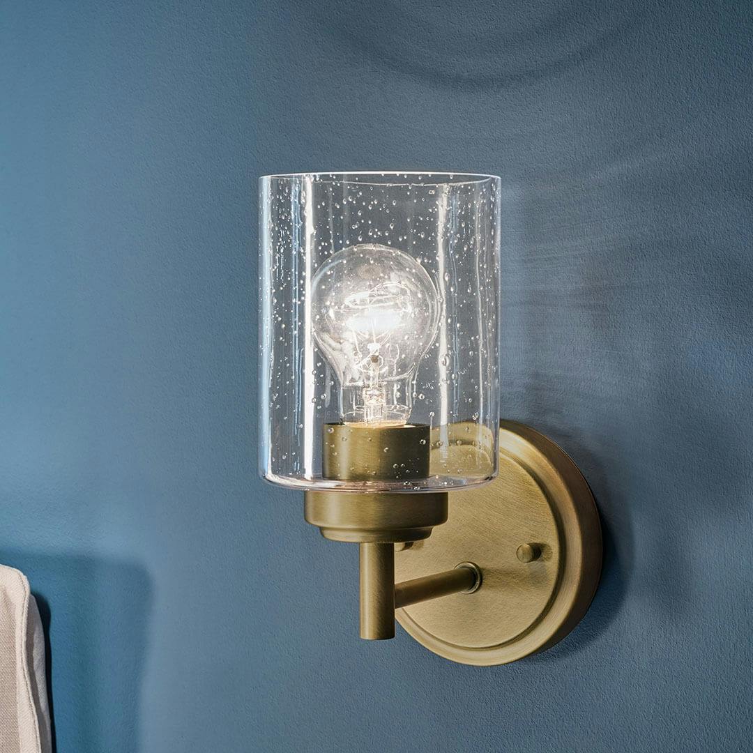 Bedroom in day light with the Winslow 9.25" 1-Light Wall Sconce with Clear Seeded Glass in Natural Brass