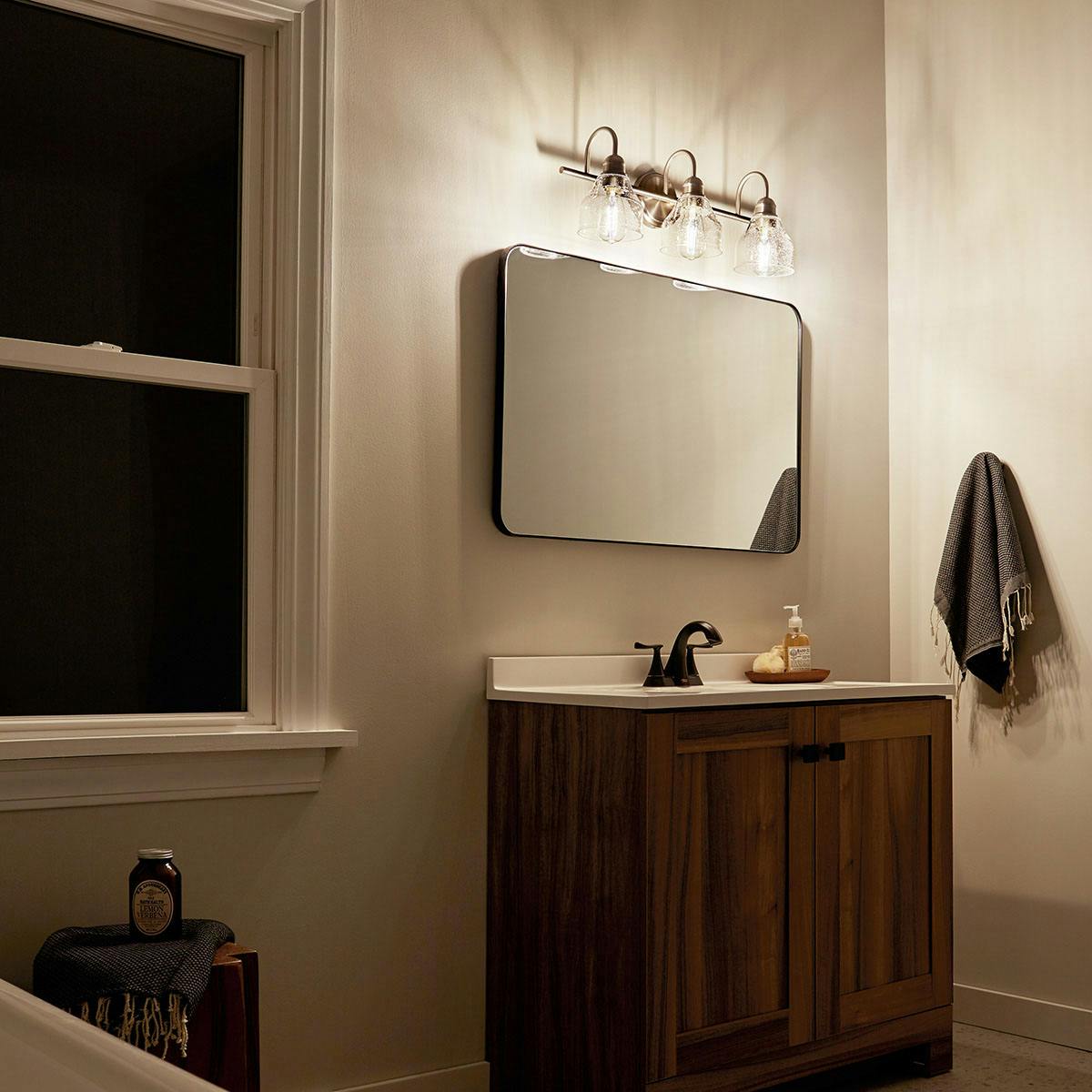 Night time Bathroom featuring Avery vanity light 45973NI