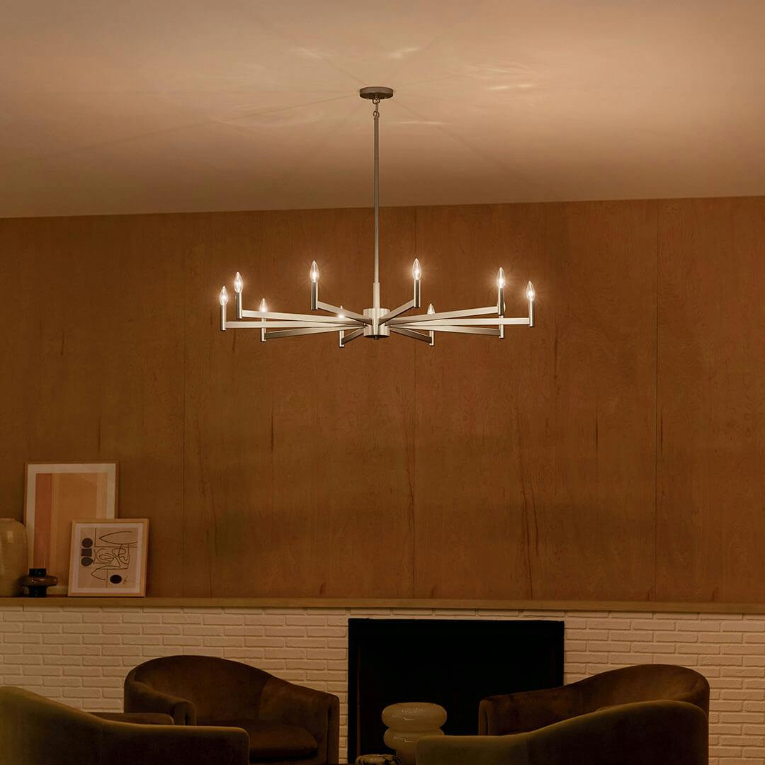 Den at night with the Erzo 48" 10 Light Chandelier in Satin Nickel