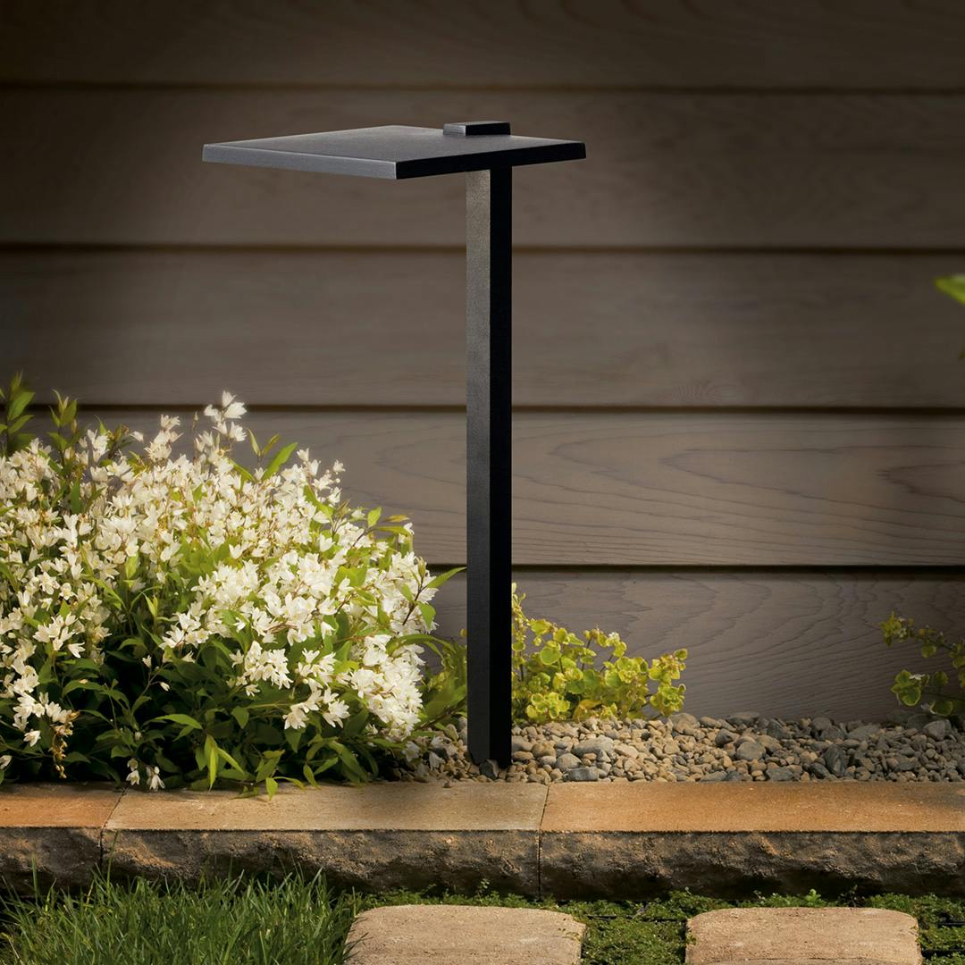 The 12 Volt 2700K LED 8" Shallow Shade Path Light in Textured Black at night on path