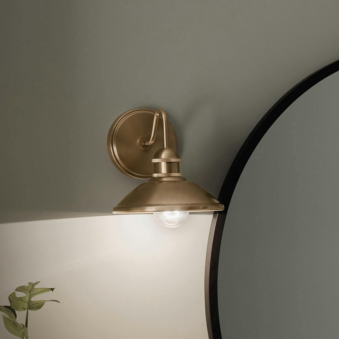 Night time bathroom with Clyde 1 Light Wall Sconce Champagne Bronze