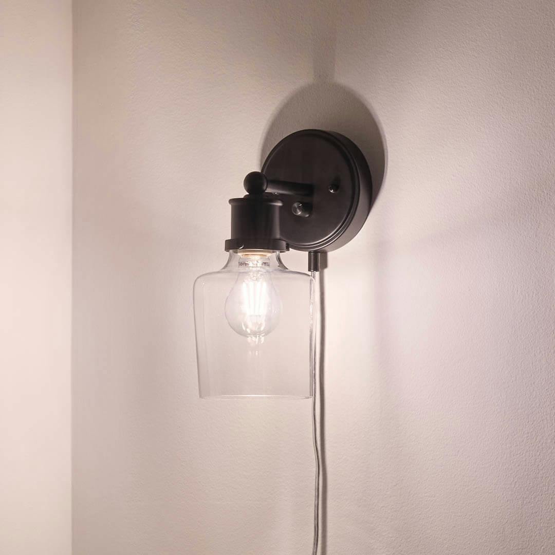 Night time breakfast nook with Helen 11 Inch 1 Light Plug-In Wall Sconce with Clear Glass in Matte Black