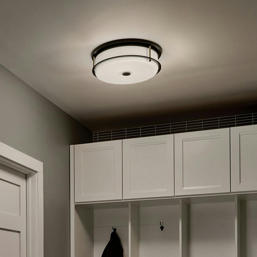 Night time mudroom with Brit 18 Inch 4 Light Flush Mount with Satin Etched Cased Opal Glass in Black and Champagne Bronze