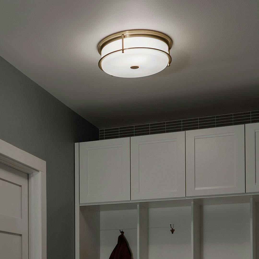 Night time mudroom with Brit 18 Inch 4 Light Flush Mount with Satin Etched Cased Opal Glass in Champagne Bronze