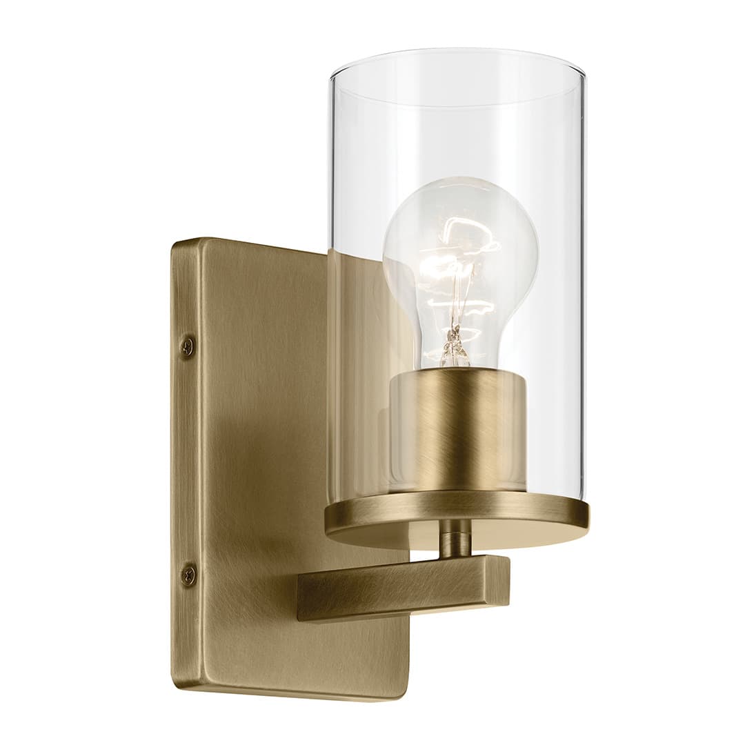 The Crosby 4.5" 1-Light Wall Sconce with Clear Glass in Natural Brass on a white background