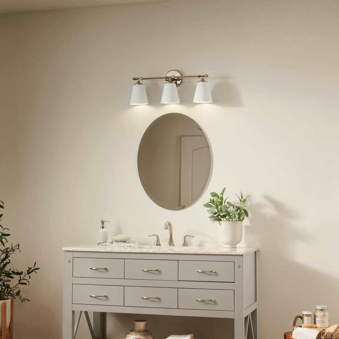 Day time bathroom with Vinoy 24.5 Inch 3-Light Vanity Light with High-Gloss White Metal Shades in Polished Nickel