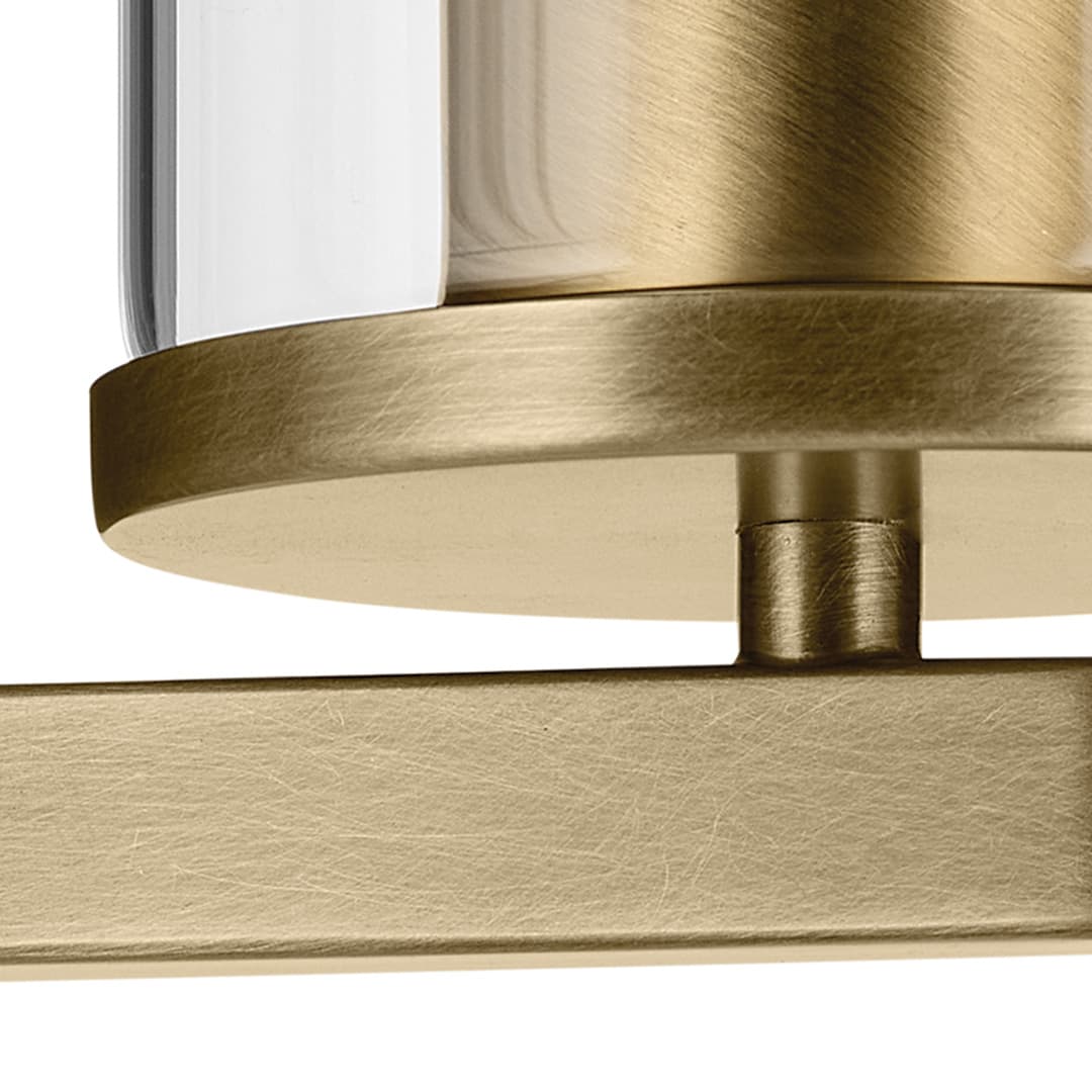 Close up view of the Crosby 4.5" 1-Light Wall Sconce with Clear Glass in Natural Brass on a white background