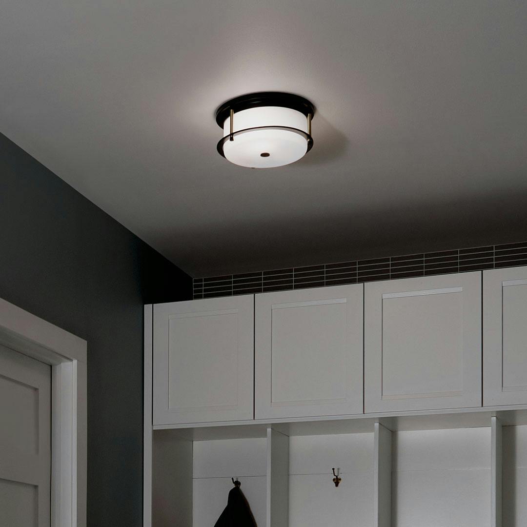 Night time mudroom with Brit 12 Inch 2 Light Flush Mount with Satin Etched Cased Opal Glass in Black and Champagne Bronze
