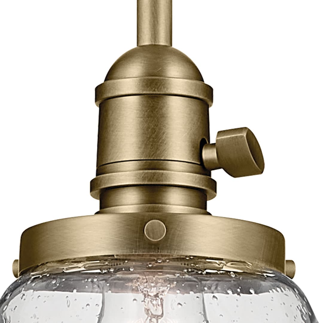 Close up view of the Avery 11.25" 1-Light Bell Pendant with Clear Seeded Glass in Natural Brass on a white background