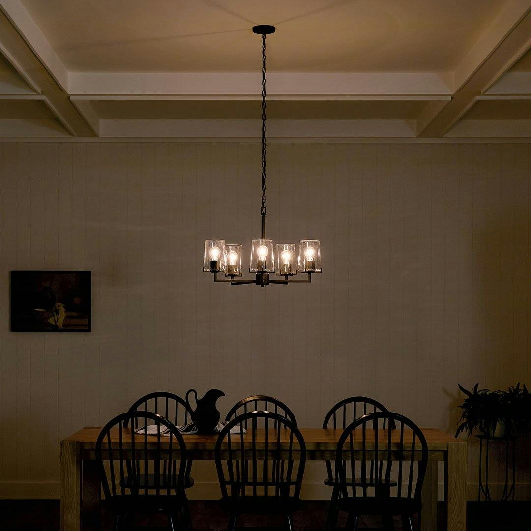 Dining room at night with the Birk 5 Light Chandelier in Black