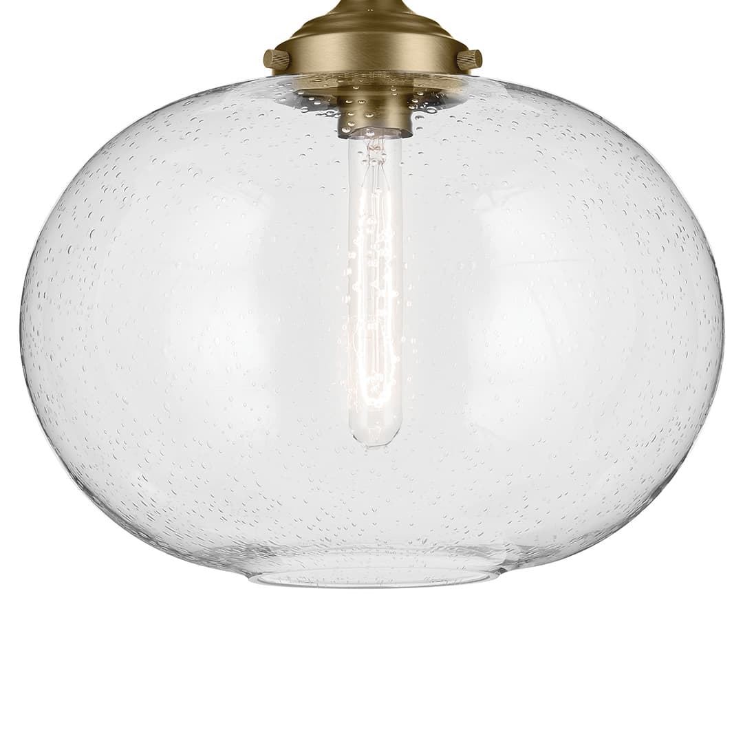 The Avery 14.5" 1-Light Flush Mount with Clear Seeded Glass in Natural Brass on a white background