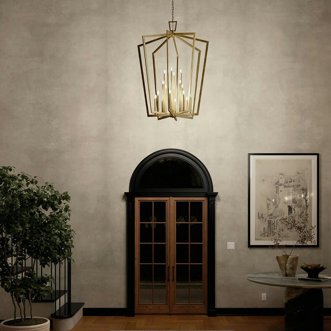 Foyer at night with the Abbotswell 49 Inch 16 Light Foyer Pendant in Natural Brass