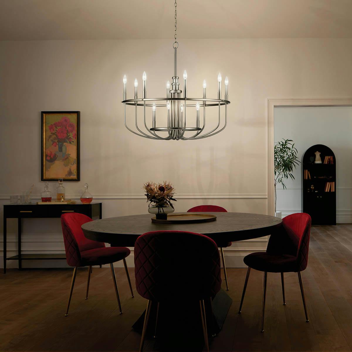 Night time dining room with Capitol Hill 12 Light Chandelier in Brushed Nickel