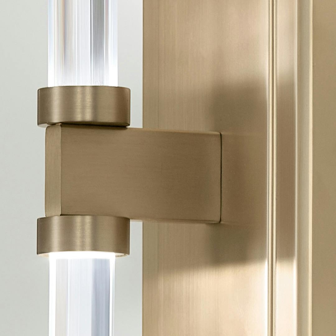 Close up of the Sycara 19 Inch 2 Light LED Wall Sconce with Faceted Crystal in Champagne Bronze on a white background