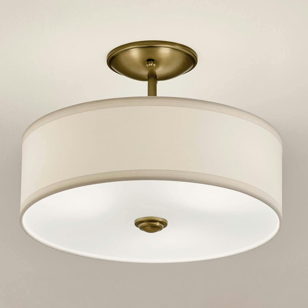 Bathroom in day light with the Shailene 10" 3-Light Small Round Semi Flush in Natural Brass