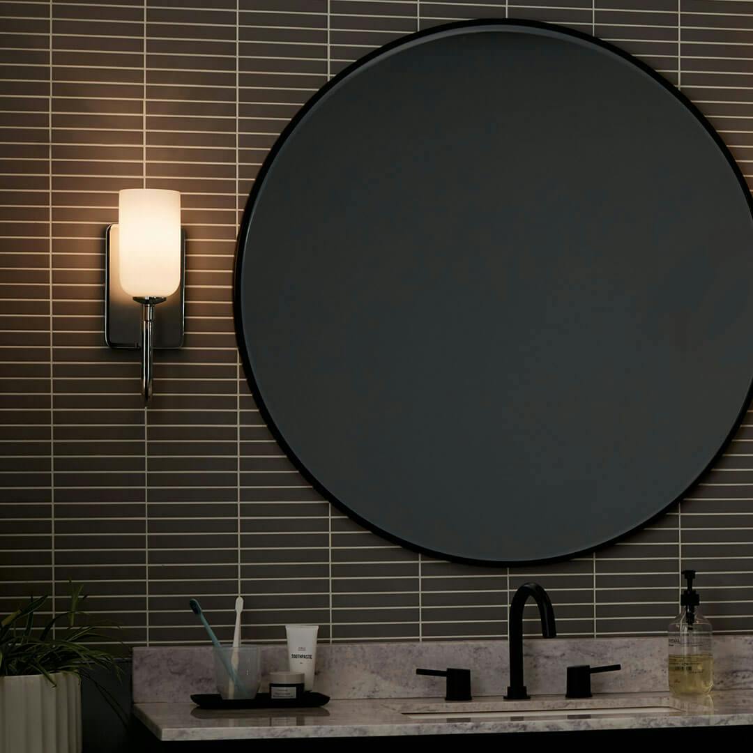 Night time bathroom with the Solia 13.5 Inch 1 Light Wall Sconce with Opal Glass in Polished Nickel with Stain Nickel