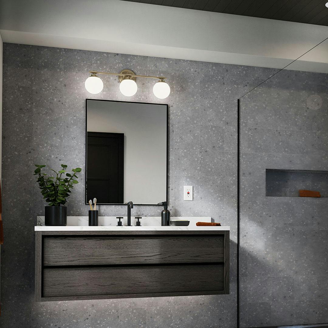 Day time bathroom with the Benno 24.5 Inch 3 Light Vanity Light with Opal Glass in Champagne Bronze
